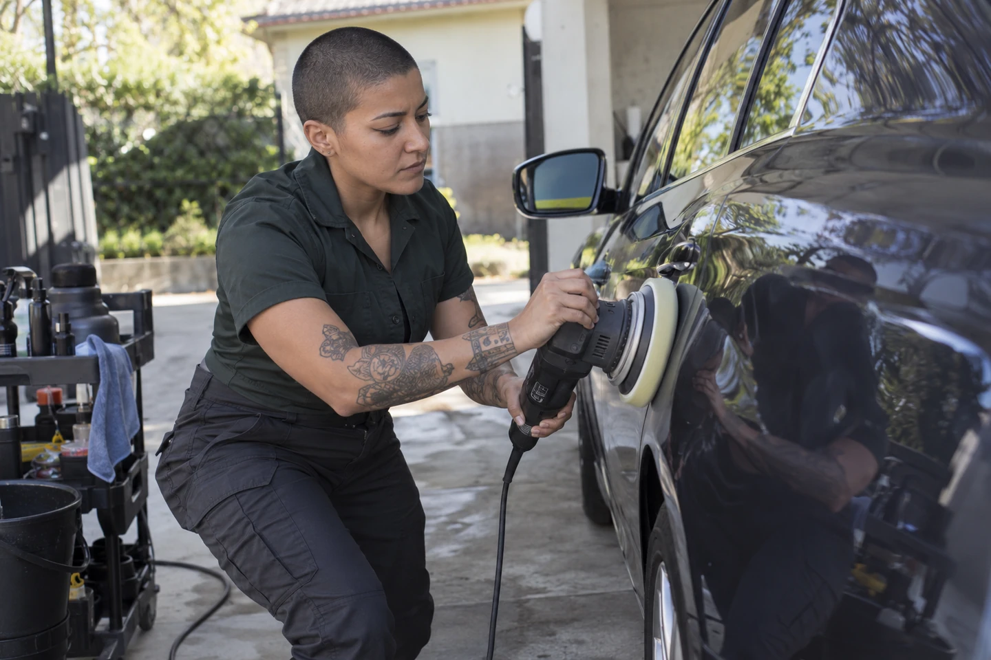 Illustrative scene of a mobile detailer polishing a vehicle at a service visit.
